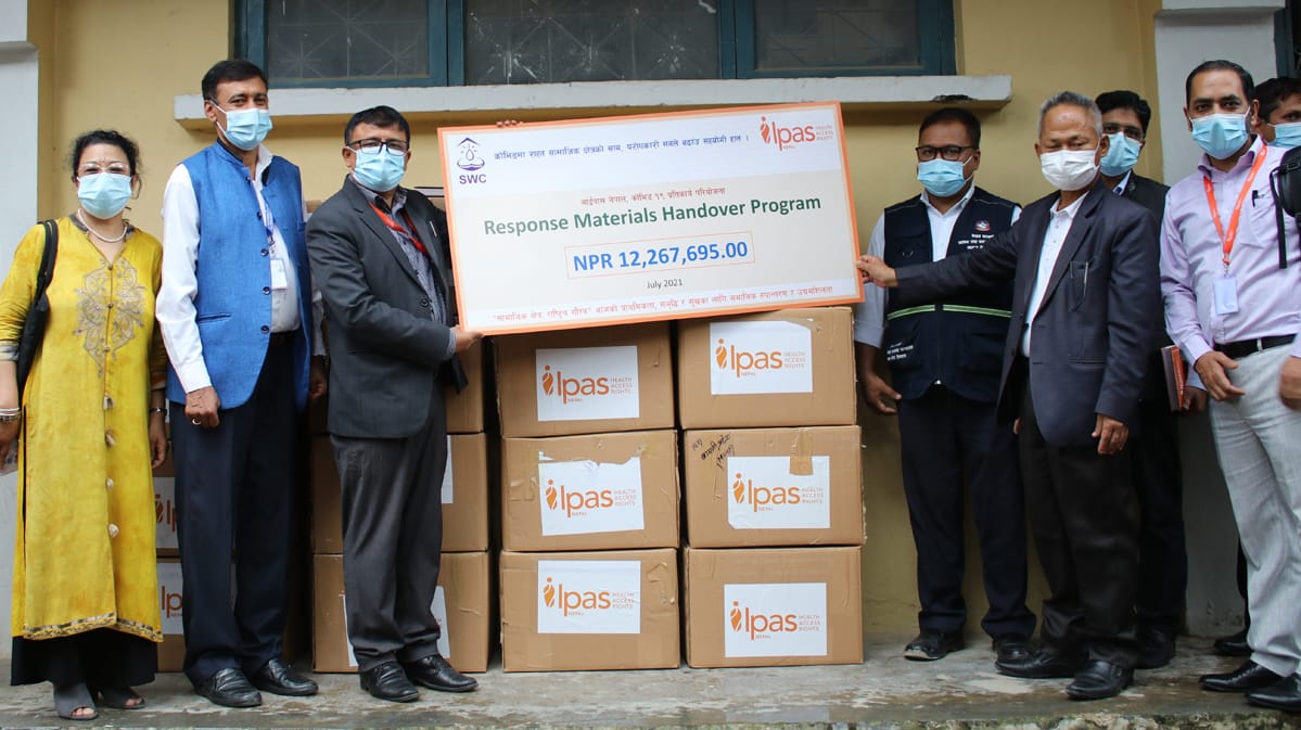 Four women holding sheets of paper